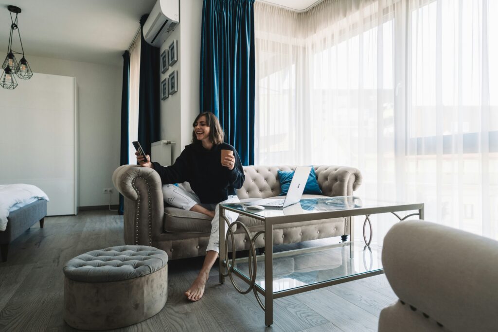 woman in black long sleeve shirt sitting on gray sofa chair using Zepeel