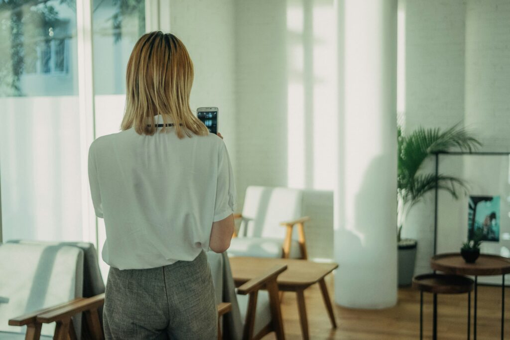 woman standing near white chair using Zepeel dating app