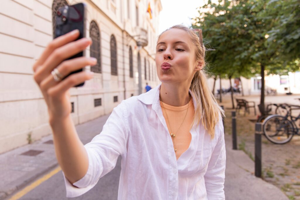 a woman recording a video message with her cell phone on Zepeel