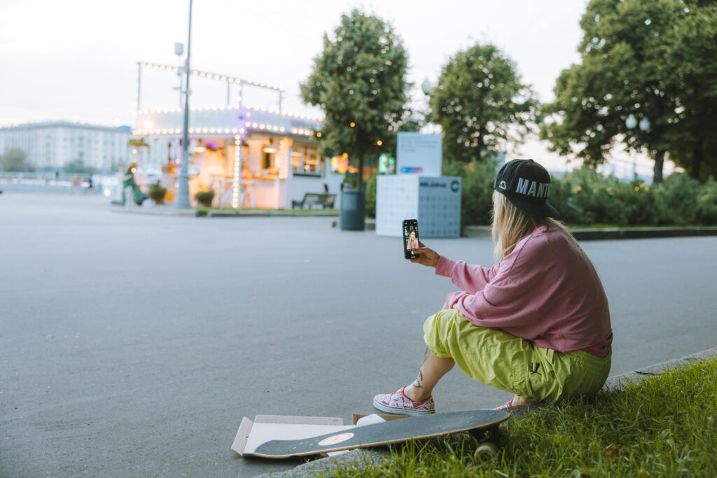 Girl sitting on side of road enjoying her virtual chat date on Zepeel