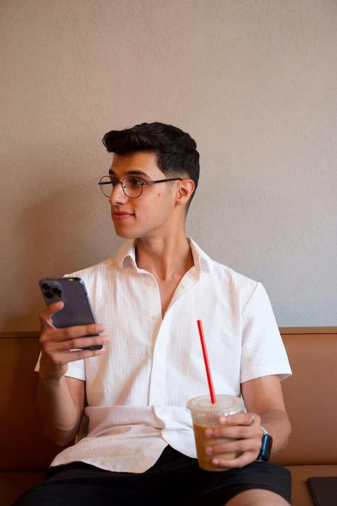 Man holding a coffe and using online video dating app Zepeel