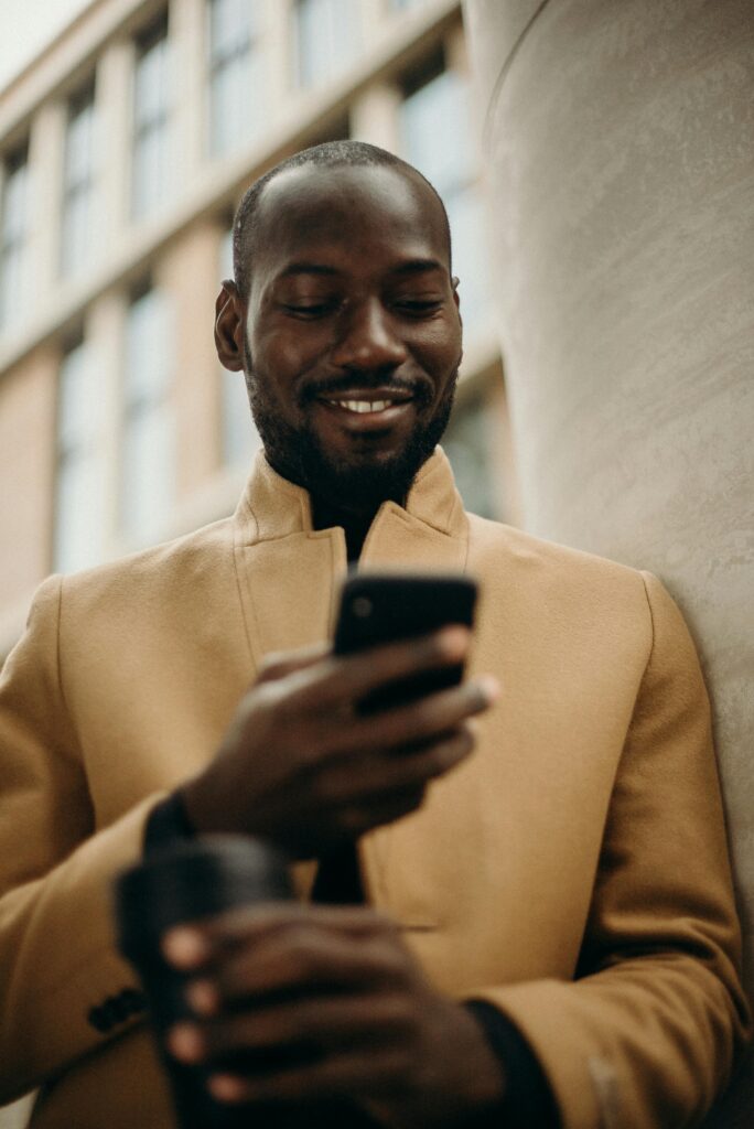 Smiling man looking at his phone Zepeel online dating app notifications